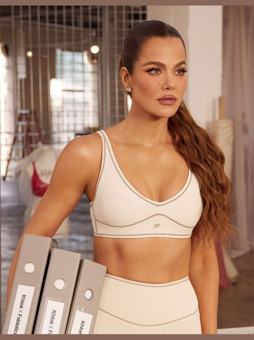Cream Fabletics PureLuxe longline low impact bra with taupe contrast piping and adjustable straps