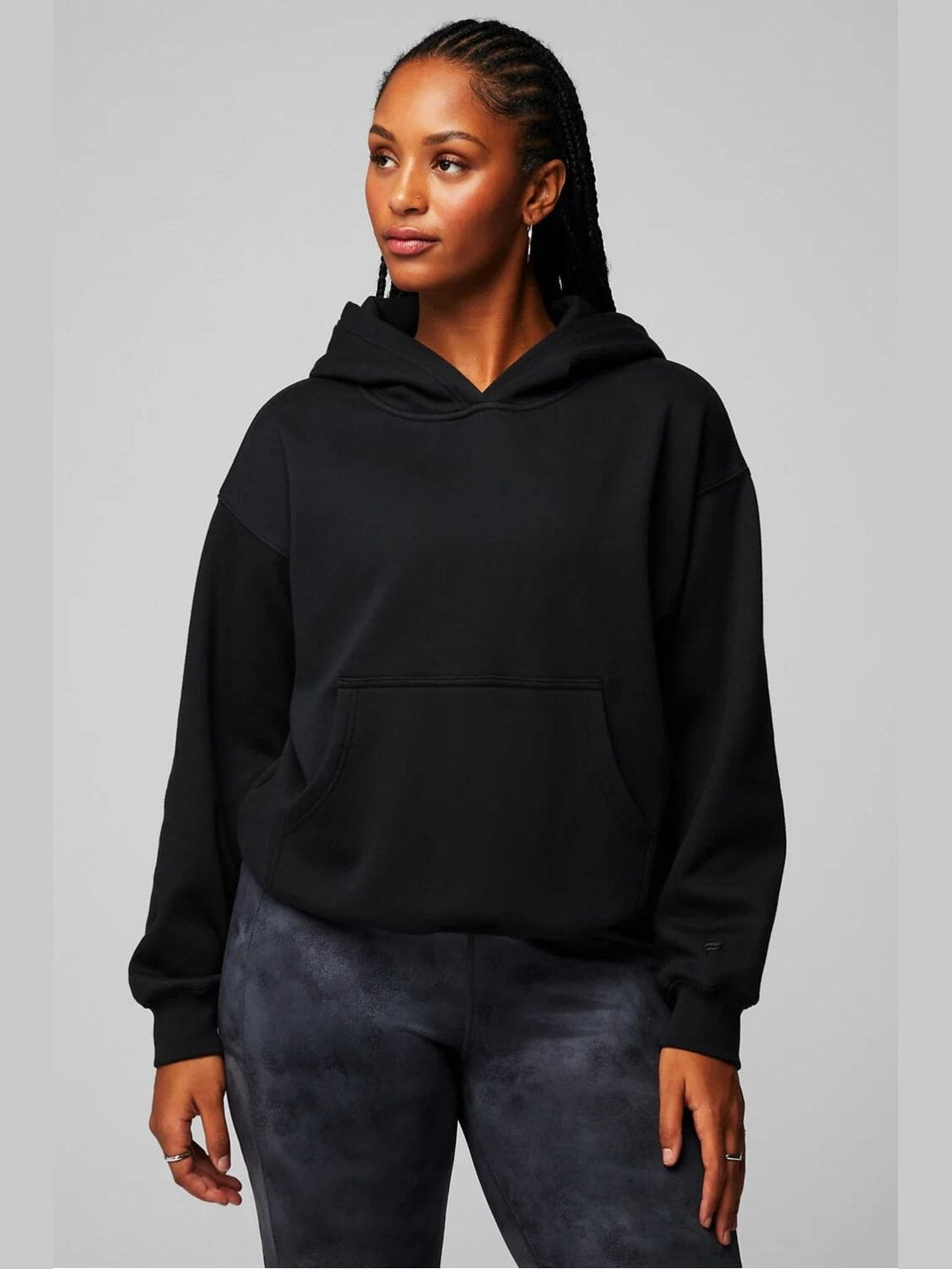 Women's black cropped Fabletics Cozy Fleece hoodie with kangaroo pocket and ribbed cuffs