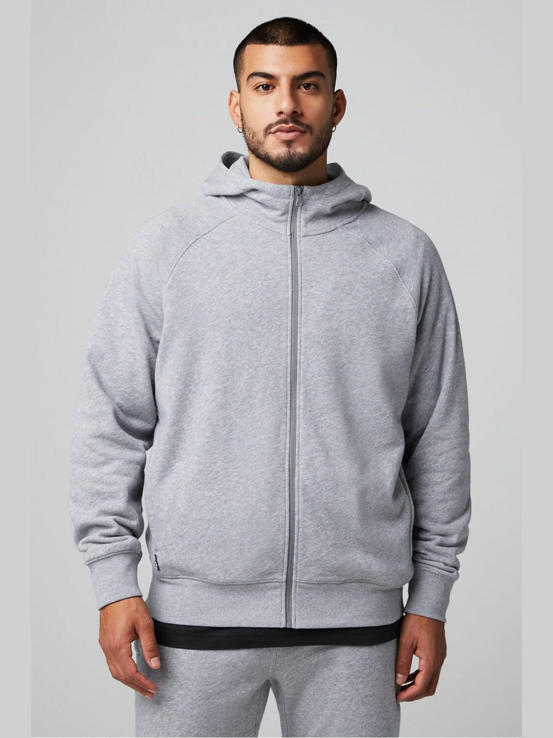 Men's heather gray Fabletics full zip hoodie with French terry fabric, raglan sleeves, and relaxed fit